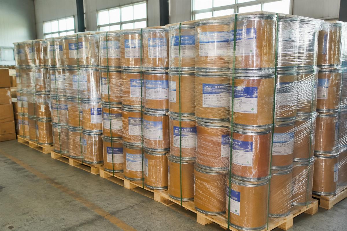 Bulk edge bander glue shipment from Chinese suppliers Bulk stacked edge bander glue containers ready for shipment from a Chinese manufacturing facility